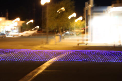 Bicycle with blue LED's on tires riding downtown Ridgecrest